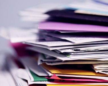 A pile of colourful files with a white background