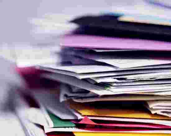 A pile of colourful files with a white background